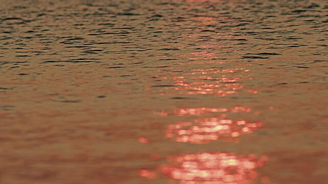 Reflective sea water texture in golden hour.