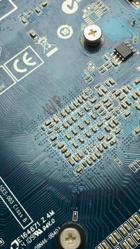 A fragment of an electronic printed circuit board with tracks and connections. Vertical video.
