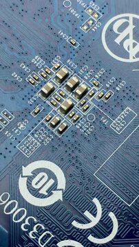 A fragment of an electronic printed circuit board with tracks and connections. Vertical video.