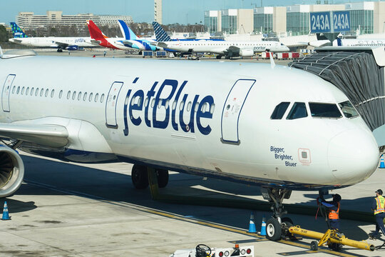 A JetBlue airplane waits to board passengers at Orlando International Airport in Orlando, Florida on January 19, 2026.