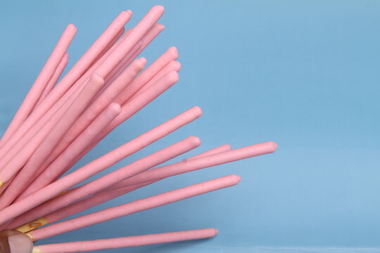 biscuits stick with strawberry cream on blue background