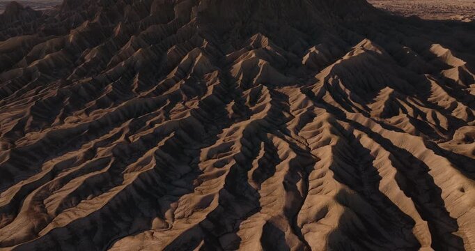 Patterns of winding erosion ridges across dry Utah desert badlands terrain
