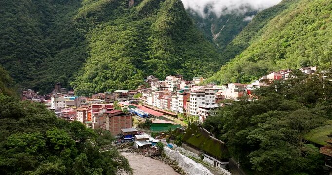Aerial view of a swollen river rushing through the town of Aguas Calientes, Peru, the gateway to the ancient ruins of Machu Picchu