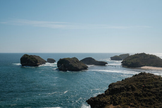 Scenic Kasap Beach with rocky islands and clear blue ocean in Pacitan