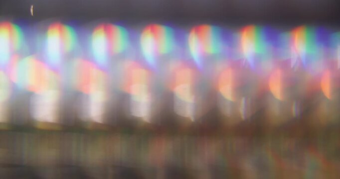 Defocused luminosity. Leak lens. Neon color kaleidoscopic reflection spin texture. Purple red green fluorescent glow abstract background.
