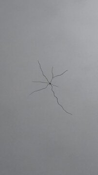 Crack in gray wall background.