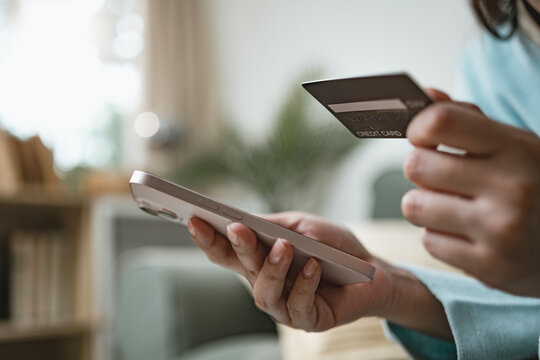 User shopping online with credit card and smartphone using buy now pay later service, representing flexible payment options, digital finance, and modern e-commerce checkout experience.