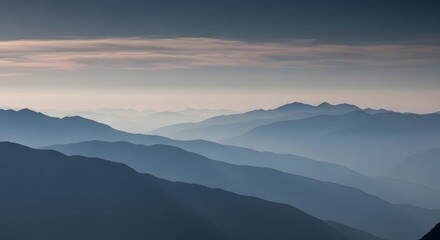 Obraz premium Serene layered mountain ranges fade into soft atmospheric haze under the gentle glow of twilight creating a tranquil and vast landscape view