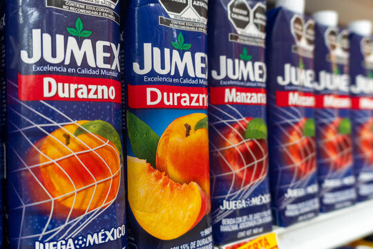 Villa de Alvarez, Colima. Mexico. March 6, 2026: Vibrant Retail Display of Peach and Apple Fruit Drink Cartons Jumex Brand Lined Up on Grocery Store Shelf