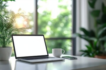 Fototapeta premium Minimal bright home workspace with open laptop showing blank white screen, coffee mug, smartphone and potted plants on clean desk by sunlit window conveying calm focused morning