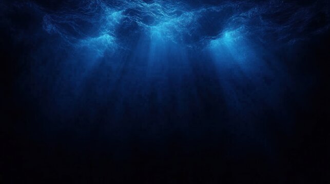sunlit ocean surface with shafts of blue light piercing into dark deep water, evoking calm mystery and solitude