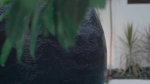 A water feature ripples as water cascades down the side of the structure. Handheld motion