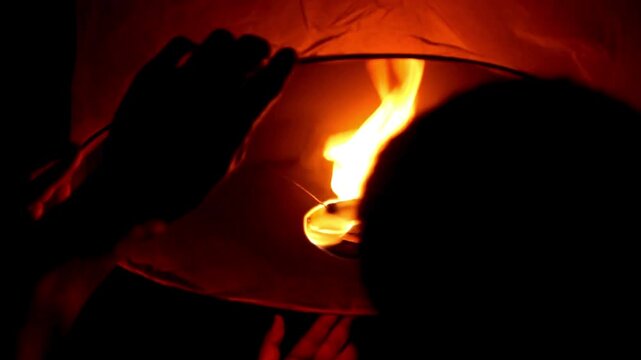 Young people release floating lanterns delicate in the night sky at Yi Peng Traditional celebration in Thailand, realistic photography, 4k 60Fps