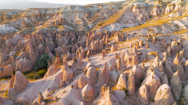 Goreme, Nevsehir, Turkey. Panoramic aerial view of Devrent Valley with distinctive rock shapes and colorful formations during evening.. Aerial View