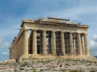 Fototapeta premium The Parthenon on the Acropolis of Athens under restoration, surrounded by scaffolding. Conservation works on the ancient marble temple highlighting preservation of Greek heritage
