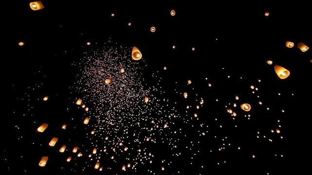 Launching Chinese paper lanterns into the night sky gracefully in the air, A multitude of paper lanterns released into the night sky. 4k animation