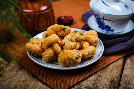 Crispy Fried Chaozhou Snack with Tea Set on Rustic Table
