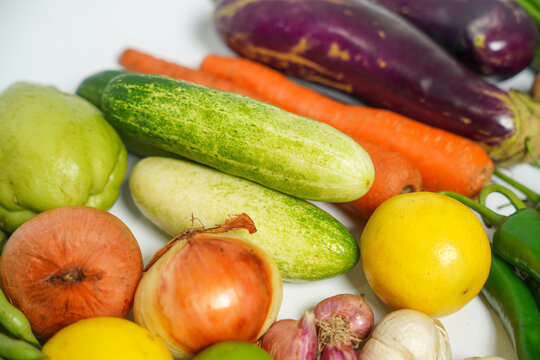 Fresh Assorted Tropical Vegetables and Citrus Fruits Close Up on White Background for Healthy Cooking
