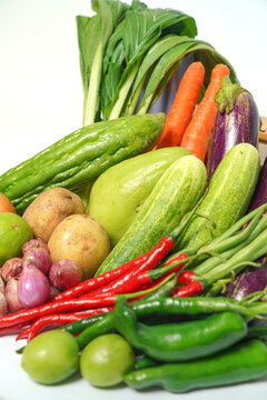 Fresh Assorted Vegetables Composition with Bok Choy, Chili, Eggplant and Cucumbers on White Background