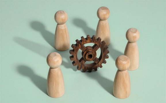 Wooden figures surround a gear symbolizing teamwork and mechanical