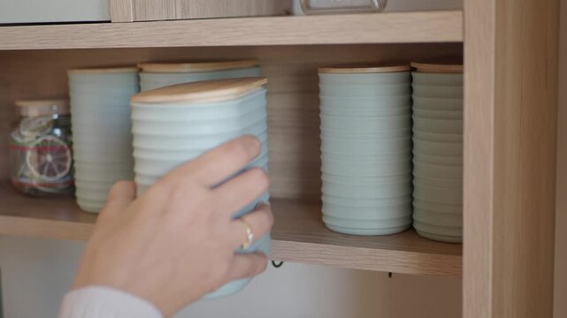 Organizing kitchen storage with blue containers on a shelf