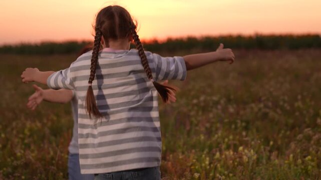 mother woman parent female, child girl kid childhood outdoors, Mother and daughter hugging in a field, Woman embracing child at sunset, Family love and togetherness, Warm evening outdoors, Parent and