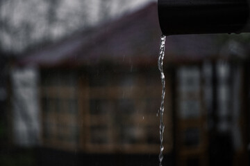 It's a rainy summer day. The rain is pouring down from the roof © Anastasia Amraeva