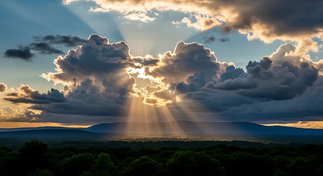 Dramatic landscape with sun rays breaking through storm clouds over mountains