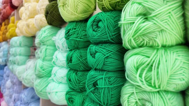 Different shades of yarn are displayed in a store
