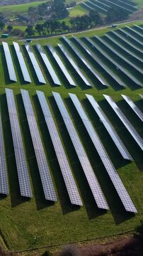 Vertical Video Rotating Aerial of Modern Solar Panel Array. Technology and nature, sustainable energy production. Green renewables, climate change solutions, future infrastructure. 9:16 reels format.
