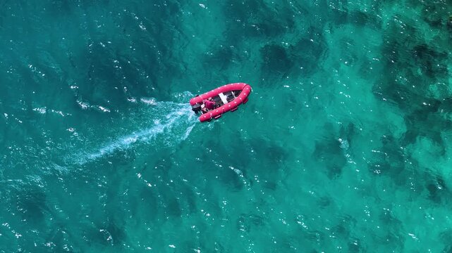 Aerial View of Red Inflatable Boat Speeding Across Turquoise Palau Waters