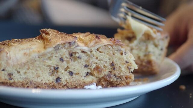 cutting apple pie with a fork on a plate 