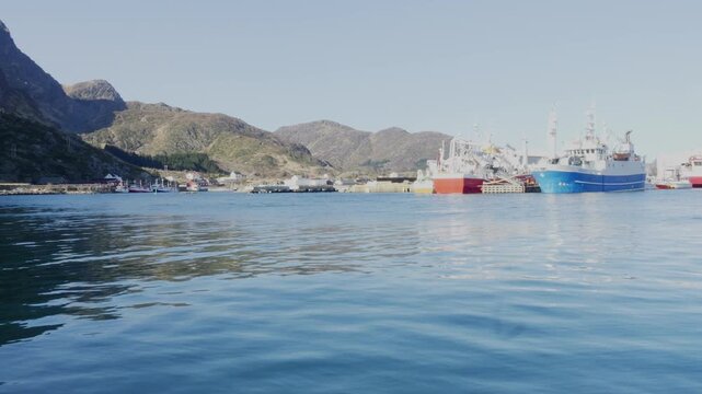 Fishing boats at rest in the harbor of the fishing village of Ballstad on a sunny calm spring day, Lofoten, Northern Norway - Spring 2026