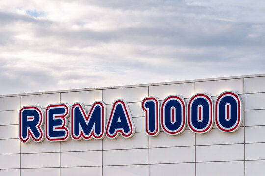 Close-up of blue and red Rema 1000 brand logo on facade of supermarket in Haderslev, South Jutland, Southern Denmark