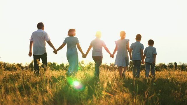 happy family, parents man woman holding children hands sunset park, mother father parents kid outdoors nature, childhood joy in golden sunshine, carefree kids in a rural field, group celebration at