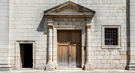 Fototapeta premium Stone facade with a wooden door and classical architectural classical architecture
