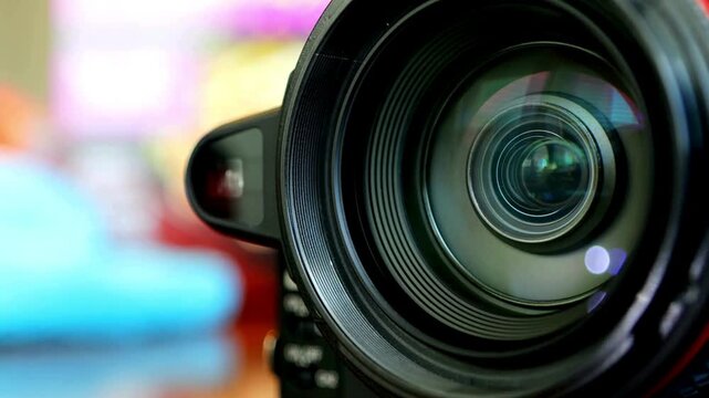 Television, movie, film video camera lens while Zooming in. Camera Lens Zooming In And Out To Focus A Sharp Image And To Capture Photograph Or Video.
