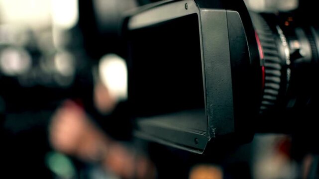 Detailed shot on the lens scale of film camera while the zoom wheel is turning. Television, movie, film video camera lens while Zooming in, close up.