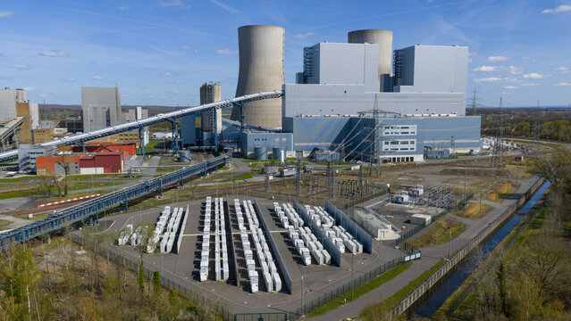 Aerial view of the RWE Westfalen power plant featuring massive cooling towers, industrial buildings, and a large battery storage system Hamm, Nordrhein-Westfalen, Germany.