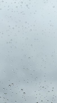 The weather is bad. Raindrops glisten on the windowpane against the backdrop of a gloomy, cold sky. It doesn&rsquo;t feel cozy - Vertical video
