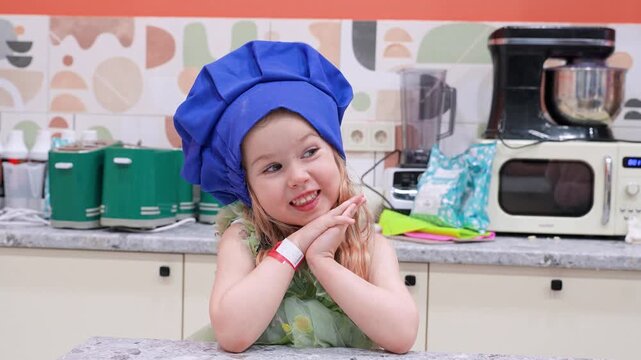 Little child in chef's hat claps her hands. Saint Petersburg, Russia - 16 Apr 2026