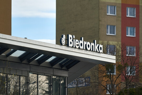 The exterior sign and logo of a Biedronka supermarket located in front of residential apartment blocks in Gdansk, Poland.