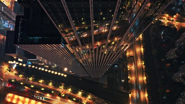 time lapse of traffic in modern city at night, aerial view