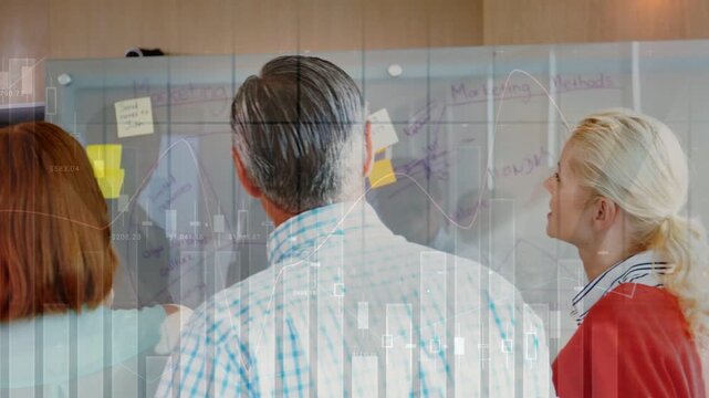 Team at glass board, lead pointing then moving notes, charts overlaying, prioritizing project goals