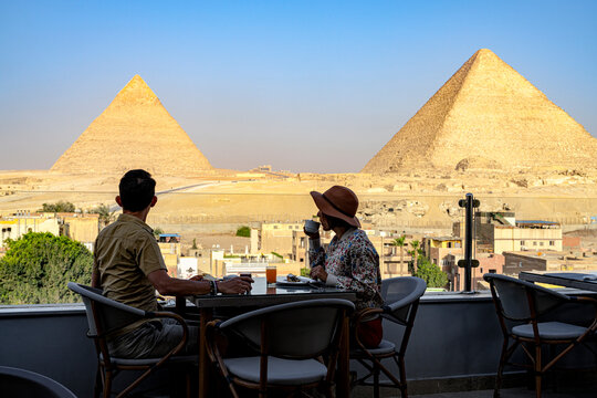 Couple having breakfast overlooking Giza Pyramids