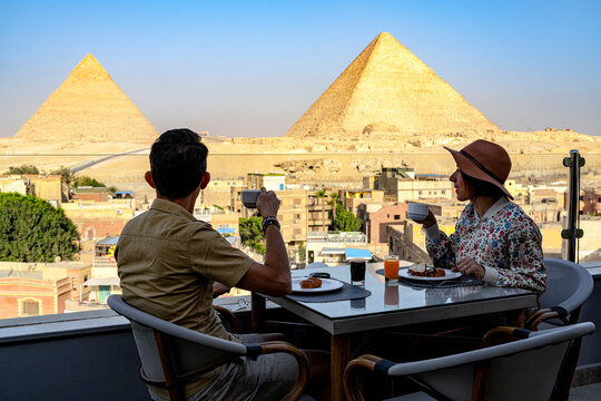 Couple having breakfast overlooking Giza Pyramids