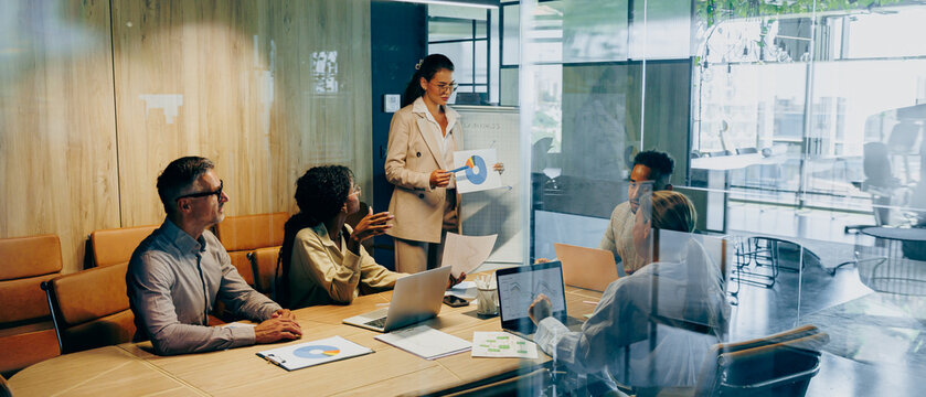 Confident Asian advisor delivers persuasive sales with data and visuals