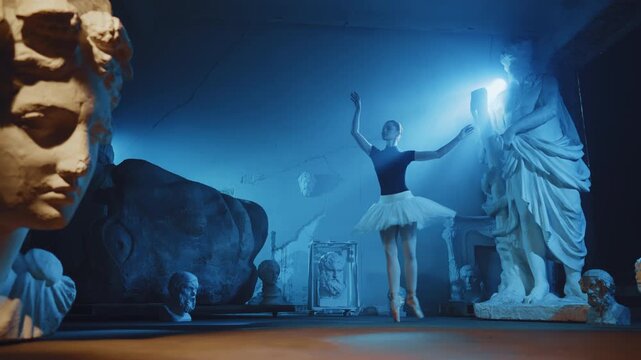 Fabulous dream of beautiful ballerina dancing in dark museum hall, slow motion. Contemporary dance performance, classical choreography and fine arts, white sculptures of ancient Greek gods and goddess