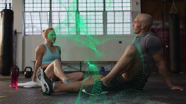 Workout partners cooling on mat, chat sparking green effect swirling during celebratory high-five