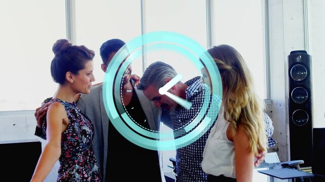 Team of four responding to appearing rotating teal clock graphic, forming supportive hug in office